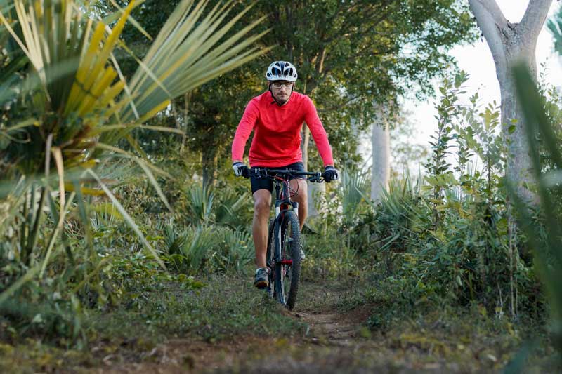 Biker riding through forest in Jarabacoa.