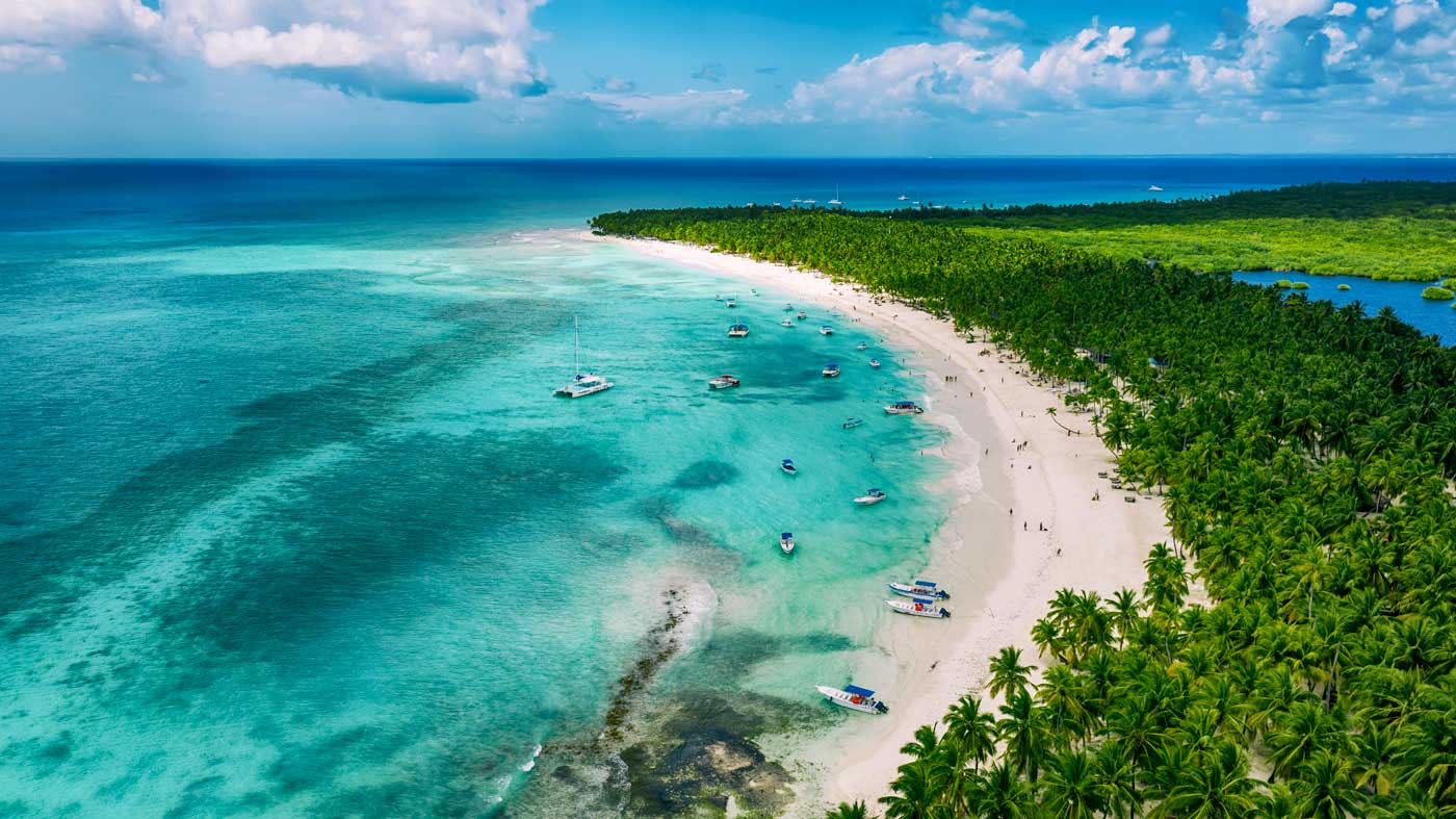 Crescent shape beach with boats.