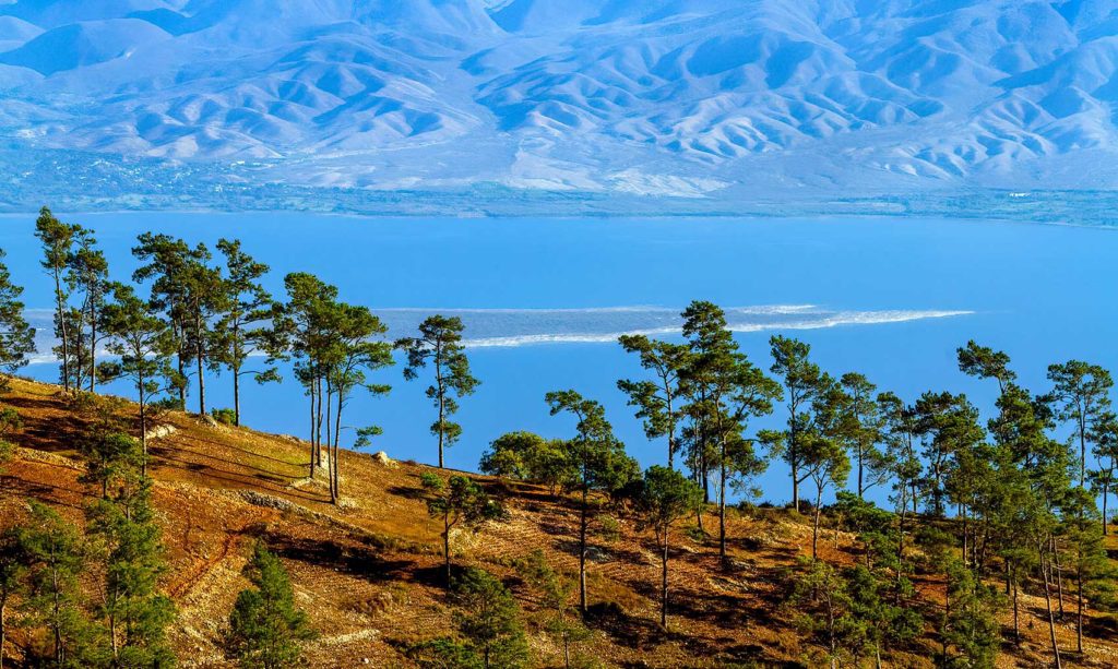 Lake between mountains and forests.