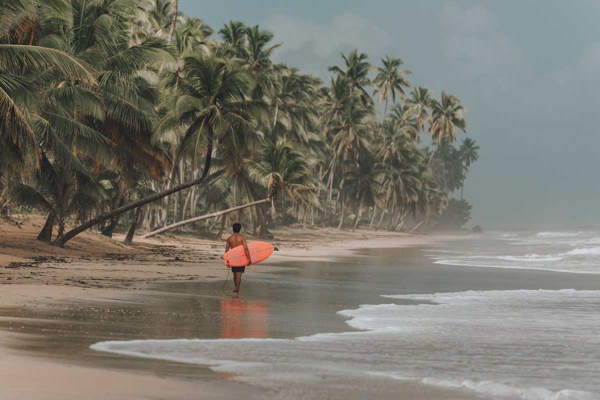 Surfer standing at the shore.