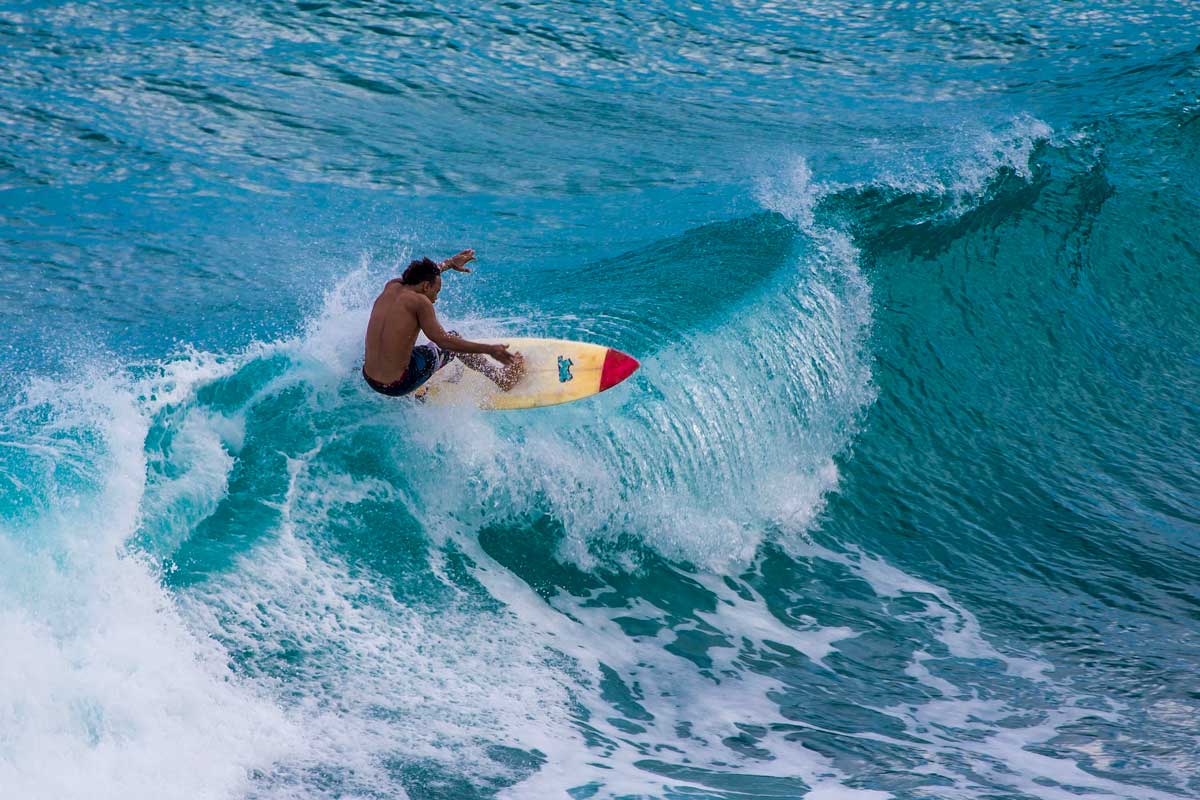 Surfer riding on waves.