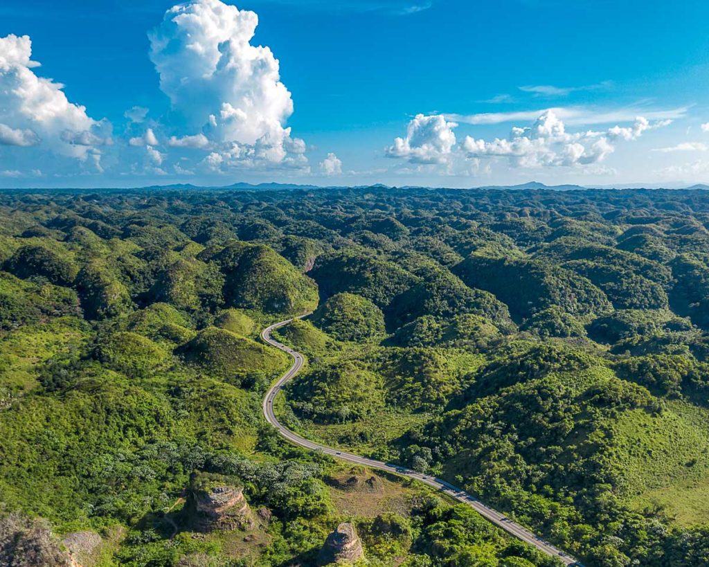 Cluster of green hills stretching into horizon.