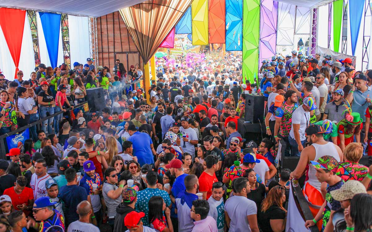 Crowd of people under Carnival tent.