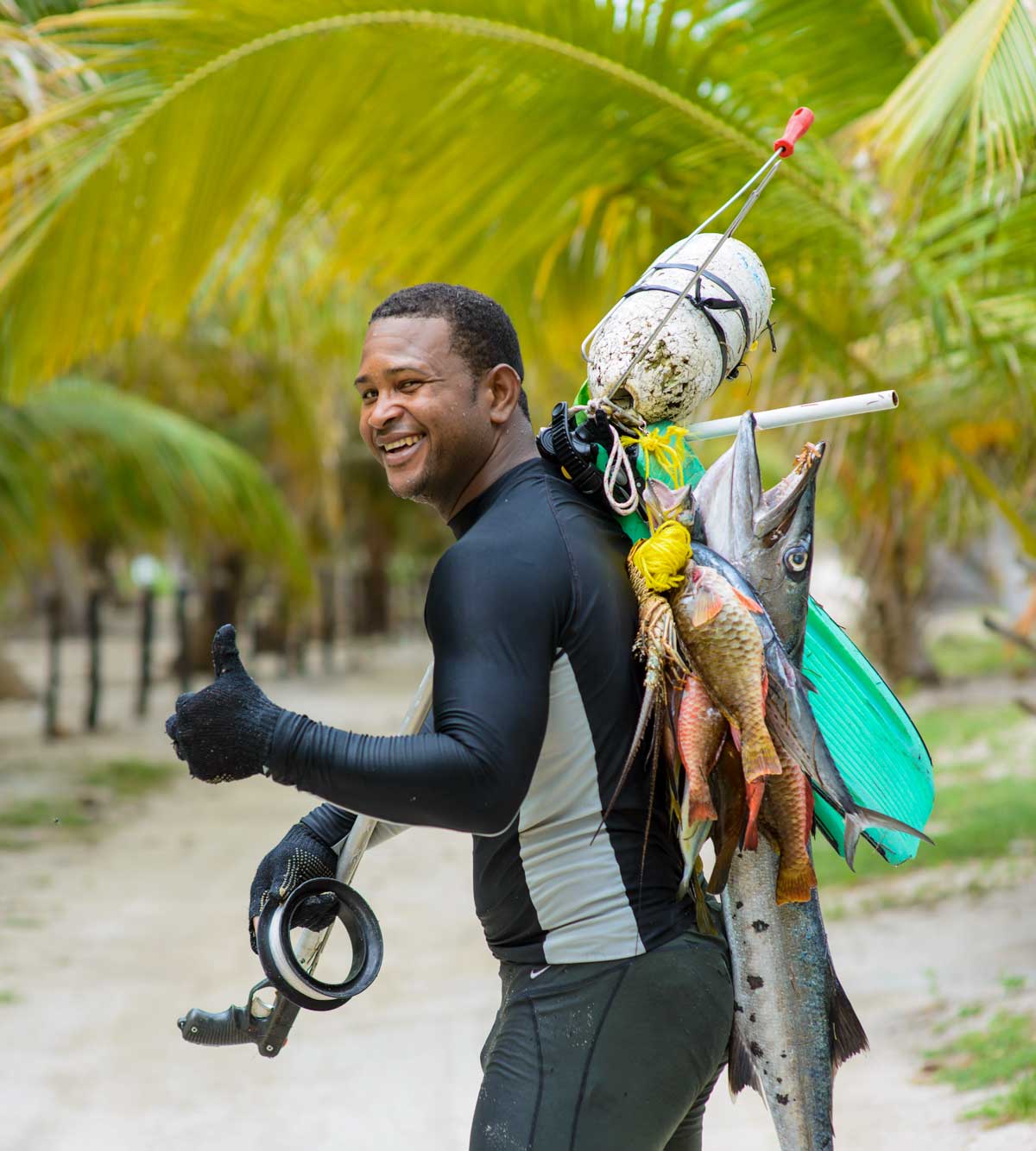 Fisherman giving thumbs up with Marlin catch.